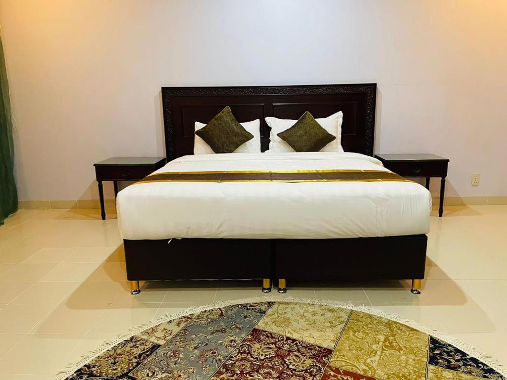 A bed or beds in a room at Arrawiya Alzahabia Hotel