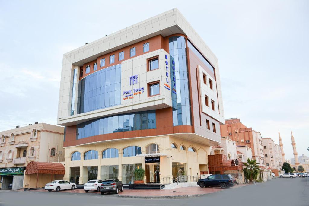 a building with cars parked in front of it at Park Town in Jeddah