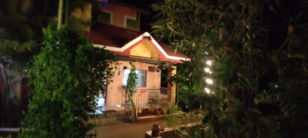 a house with a fence and a porch at night at Cheerful Villa at Chaul Alibag Near Revdanda and Nagav Beach in Alibaug