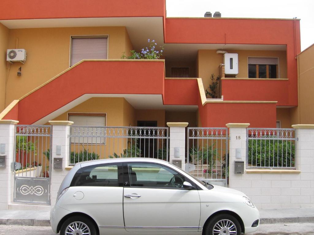 a white car parked in front of a building at B&BGalatina1 CIS in Galatina