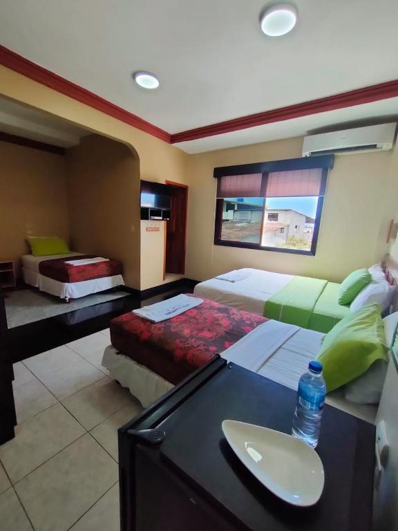Postel nebo postele na pokoji v ubytování Hotel Los Algarrobos