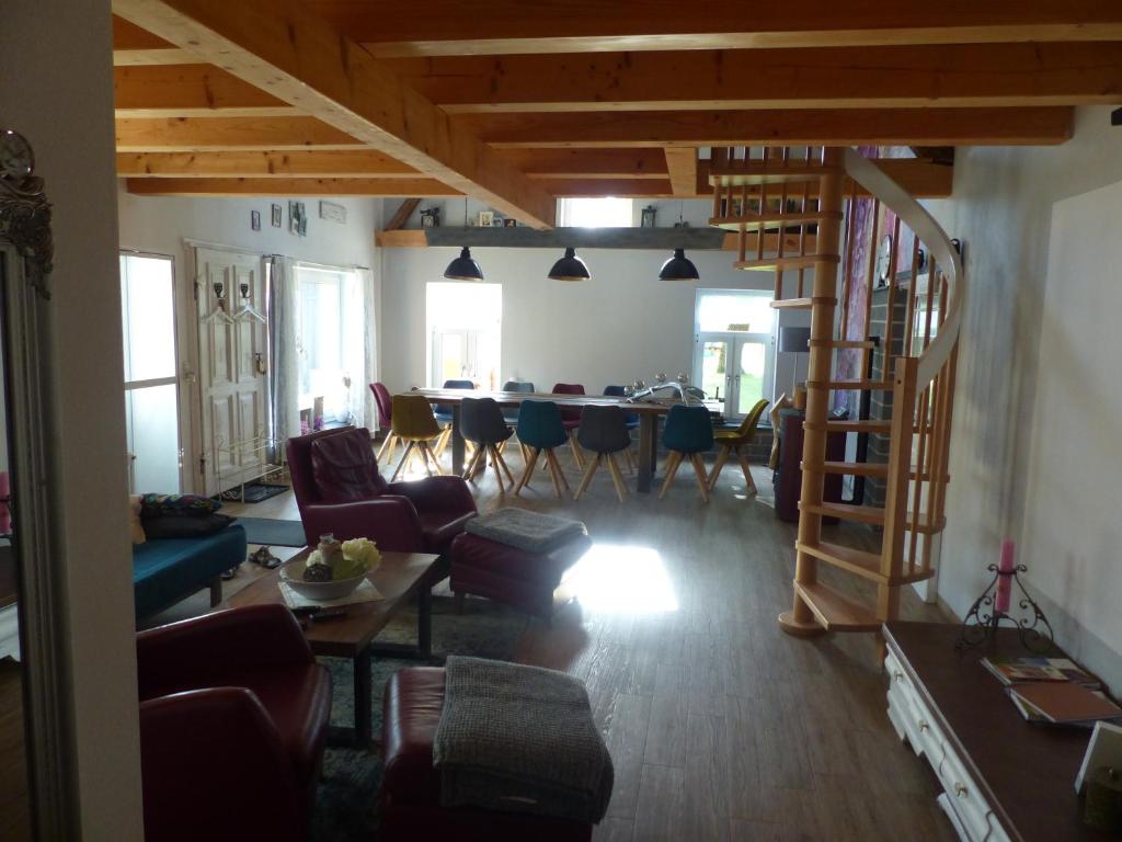 a living room with a staircase leading to a dining room at Ferienhaus Arendsee in Arendsee