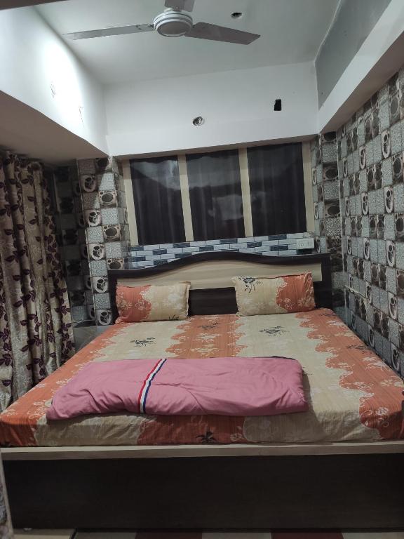 a bedroom with a large bed in a room at Budget Hotel in Patna
