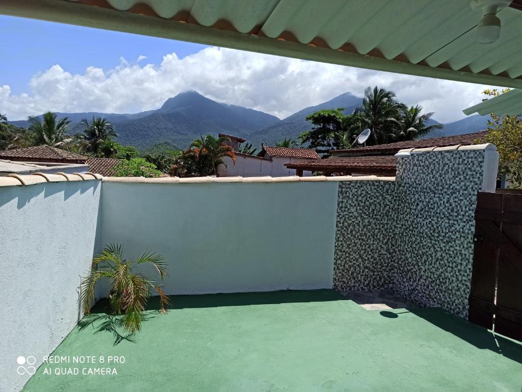 a balcony with a view of the mountains at Casa de Praia in Ilhabela