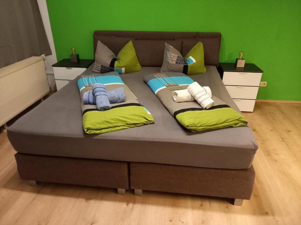 a large bed with pillows on it in a room at Bayerwald Appartement in Sankt Englmar