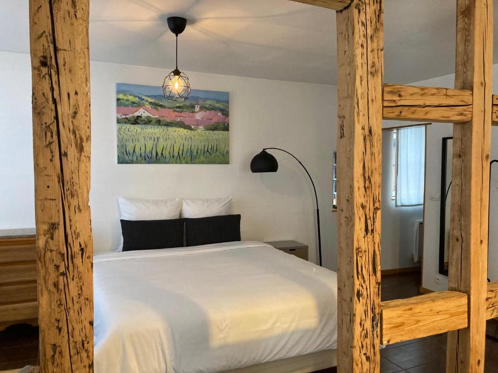 a bedroom with a wooden bunk bed and a lamp at Parenthèse Alsacienne in Schiltigheim