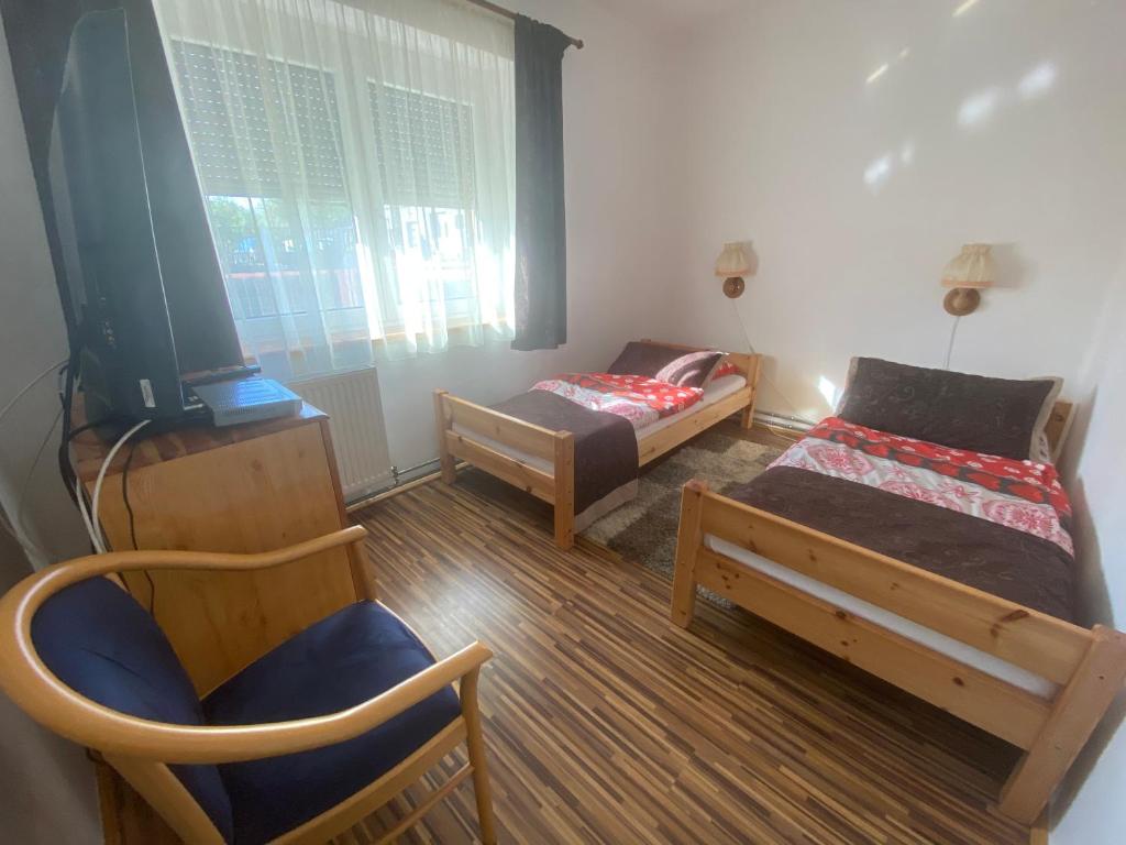 A bed or beds in a room at Bella apartman