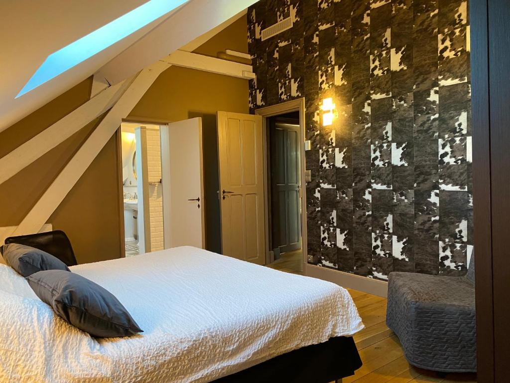 a bedroom with a bed and a wall with writing on it at Demeure Saint Louis Historic manor, City 700m, parking,A C,Clim,WIFI, heated pool, city view in Carcassonne