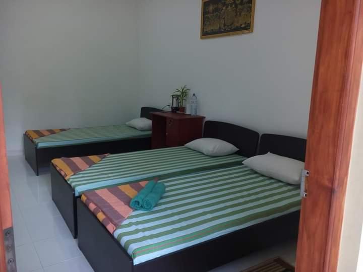 Postel nebo postele na pokoji v ubytování Dinimuthu Rest Inn