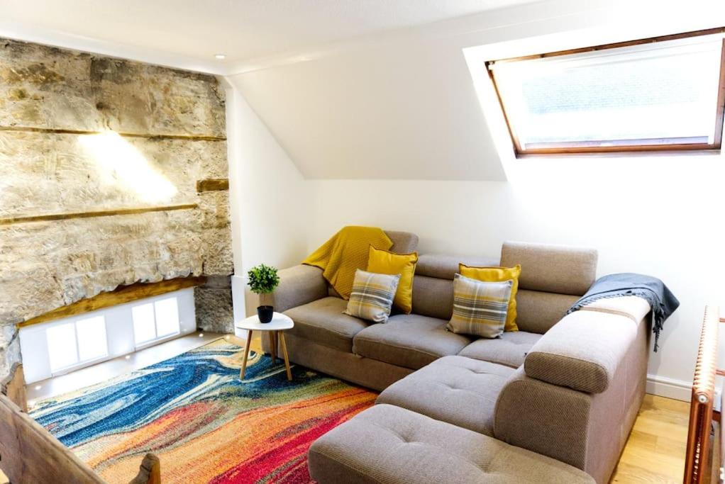a living room with a couch and a fireplace at Stunning & unique apt in Culross in Culross