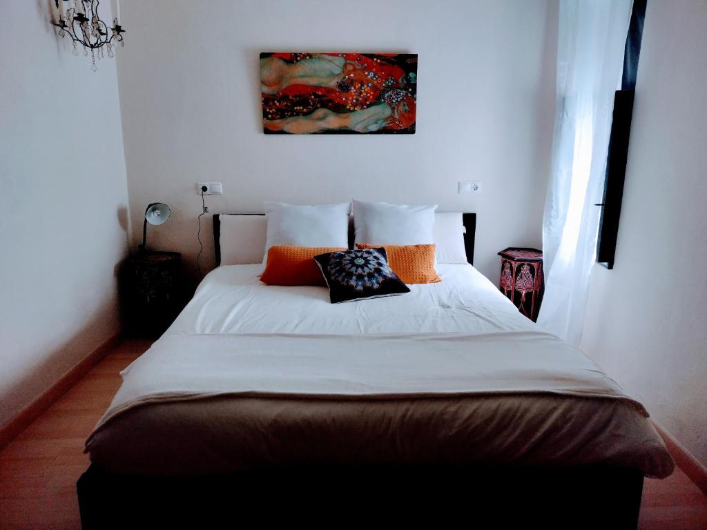 a bedroom with a large bed with pillows on it at Casa Salvadora in Algar