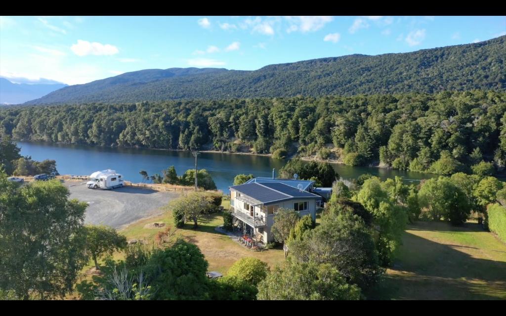 an aerial view of a house next to a lake at Glendale River View in Manapouri