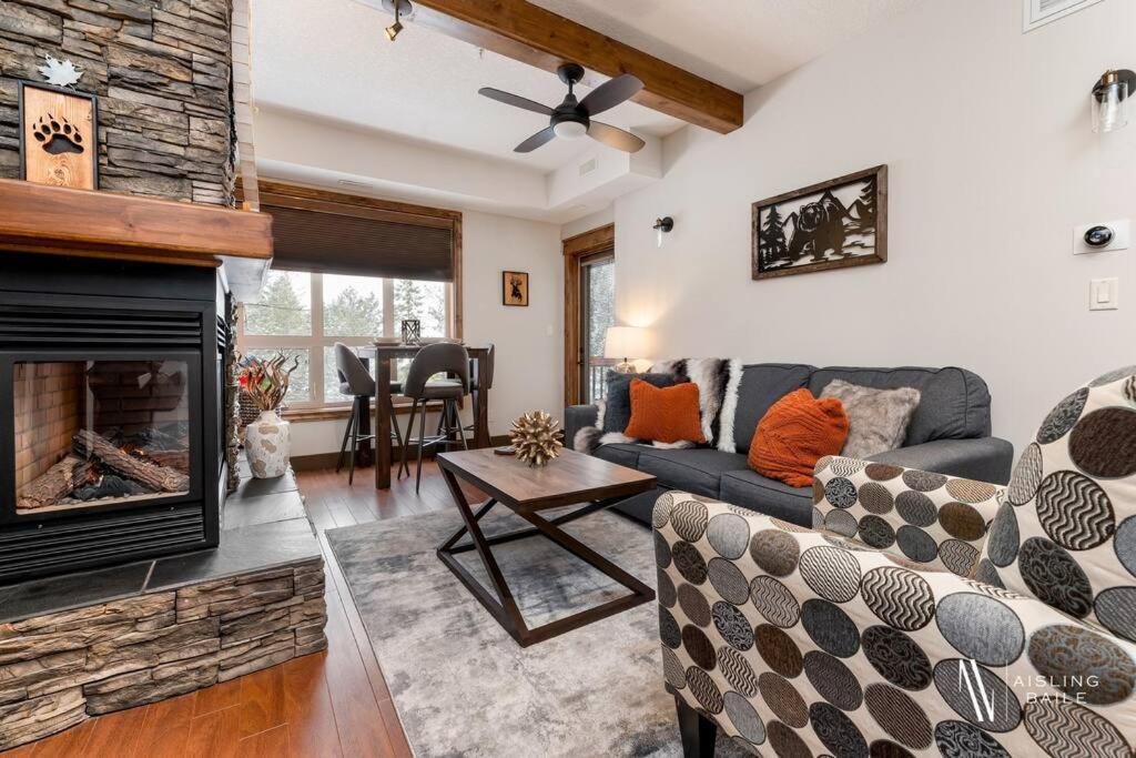 a living room with a couch and a fireplace at Heavenly Mountain Hideaway, Pool, Hot Tub in Radium Hot Springs