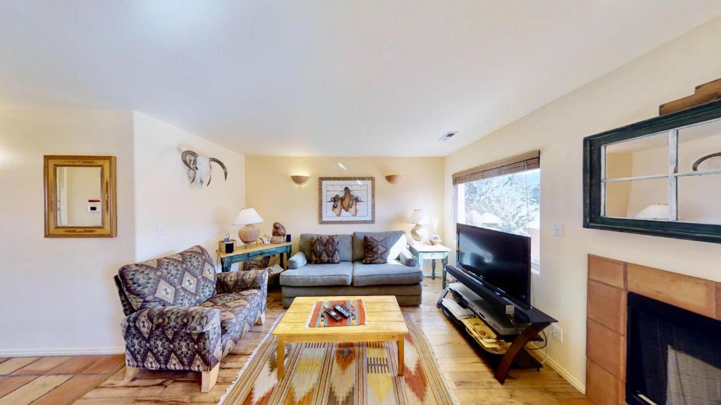 a living room with a couch and a fireplace at Sunset View #3234 in Moab