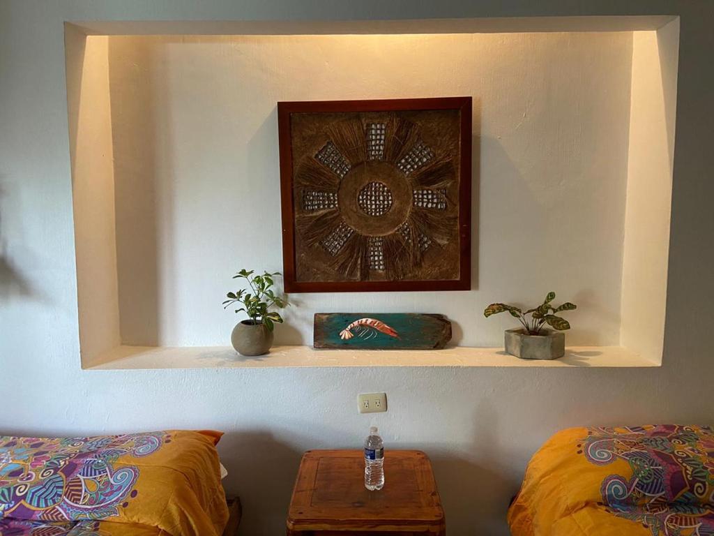 a shelf with two beds and a clock on a wall at Cabañas Laguna in Isla Aguada