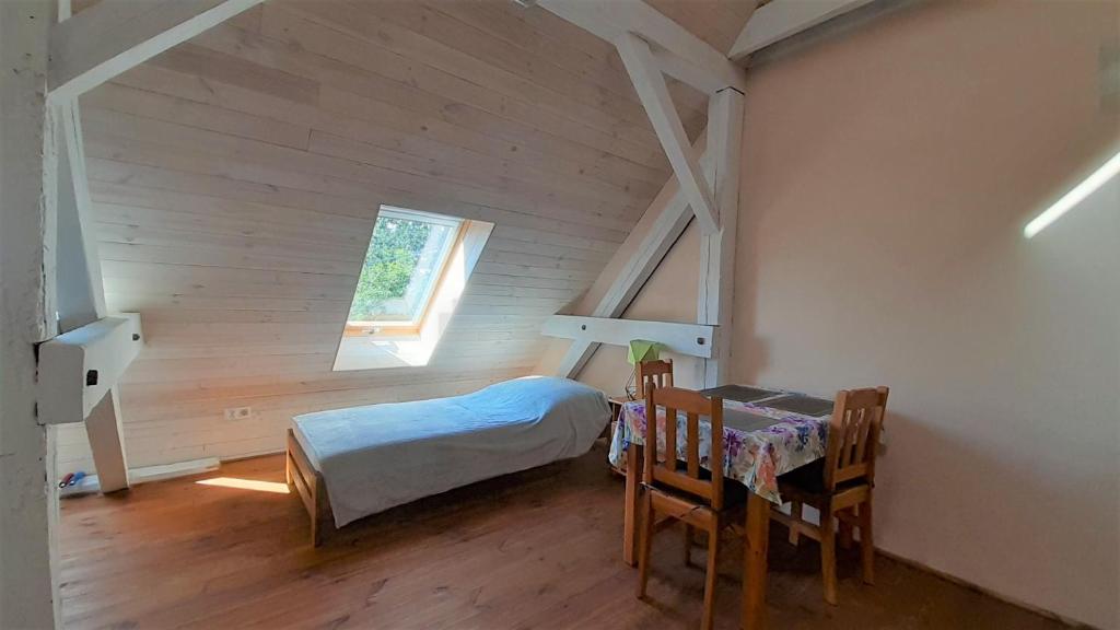 a bedroom with a bed and a table and chairs at Czarna Jachta - Na szlaku legend - - - - - Pokoje nad jeziorem in Kruklanki