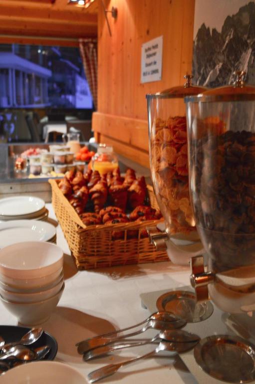 a table with a basket of food on a table at Chalet-Hôtel de l&#39;Etape in Les Contamines-Montjoie