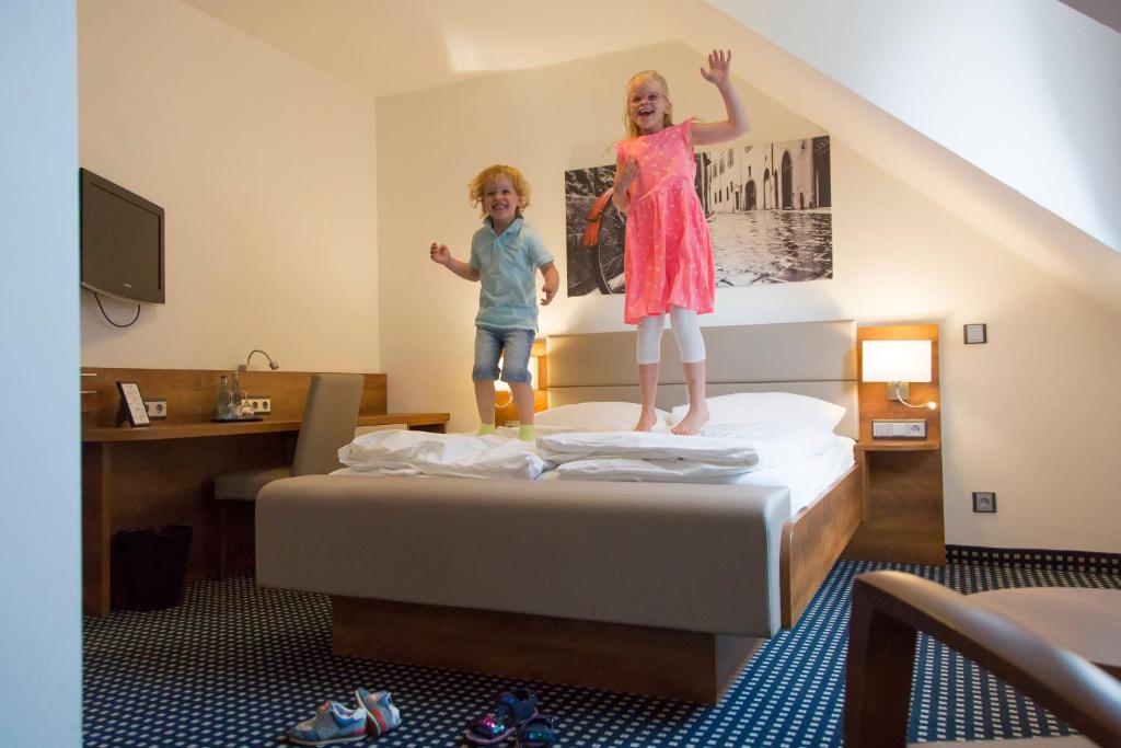 Postel nebo postele na pokoji v ubytování Hotel Greive