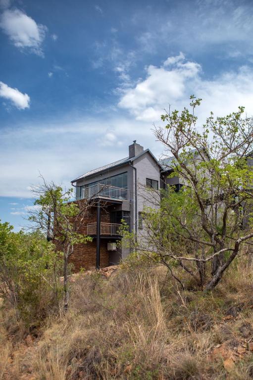 a house sitting on top of a hill at Elements Sunrise Bush Lodge in Bela-Bela