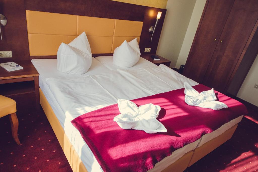 Postel nebo postele na pokoji v ubytování Hotel Arena City