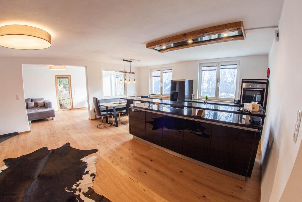 a living room with a kitchen and a dining room at Alpenblick de Luxe in Oetz