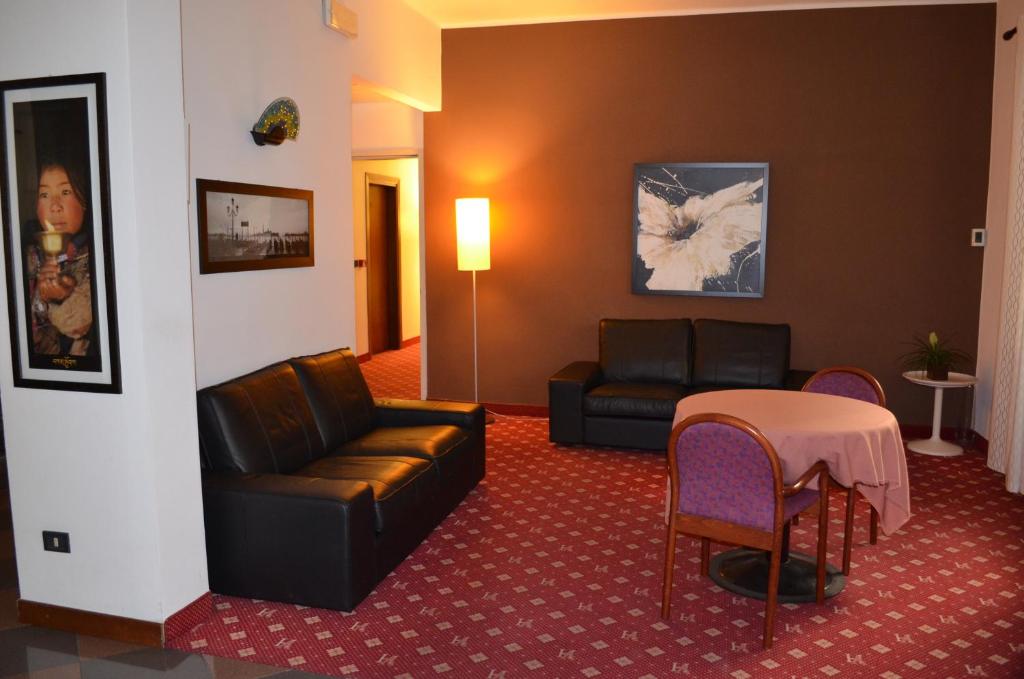 a living room with a couch and a table at Hotel Adria in Mestre