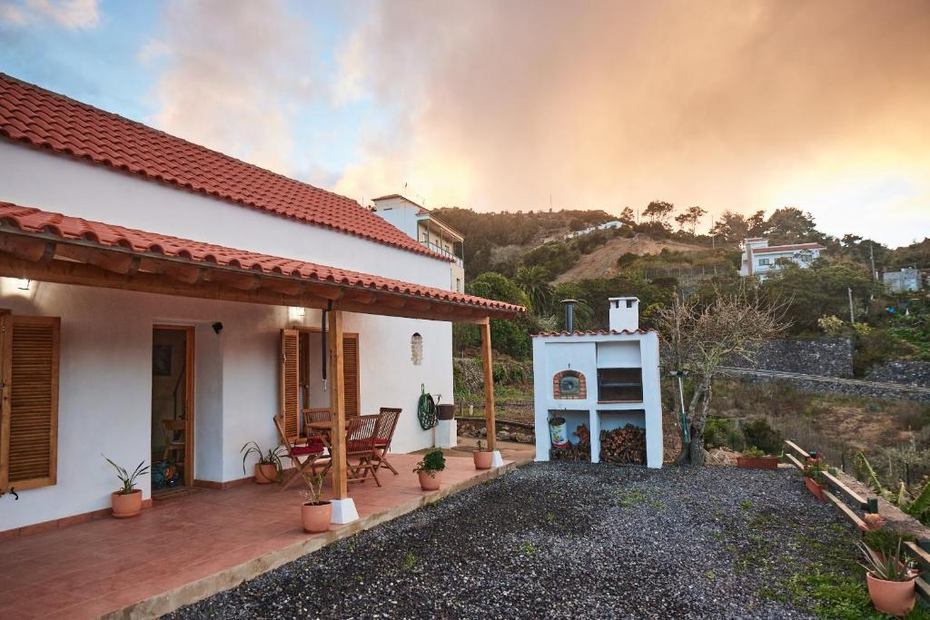 a house with a fire in the background at Sustainable Rural House La Lisa Dorada in Agulo