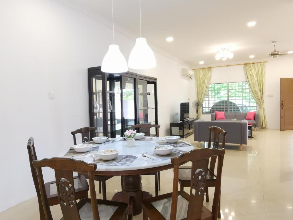 a dining room with a table and chairs at NanSang One Homestay 8pax 4Rooms in Sibu
