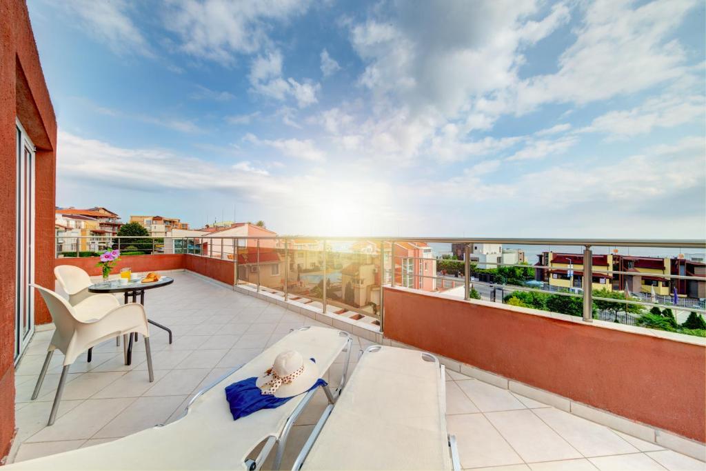 a balcony with a table and a view of the ocean at Hotel Sunny in Sozopol