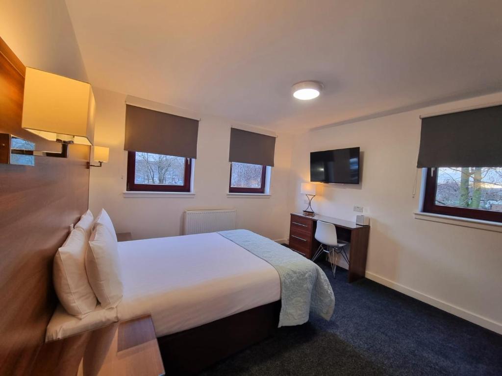 Postel nebo postele na pokoji v ubytování Premier Lodge