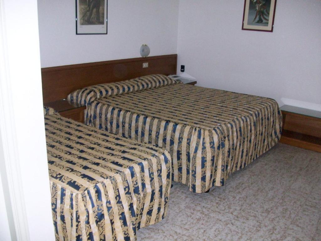 Postel nebo postele na pokoji v ubytování HOTEL SANTOROTTO di FABIO TERROSI