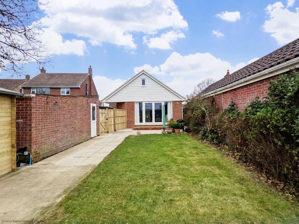 a house with a brick wall and a driveway at Ems Cottage - Emsworth in Emsworth