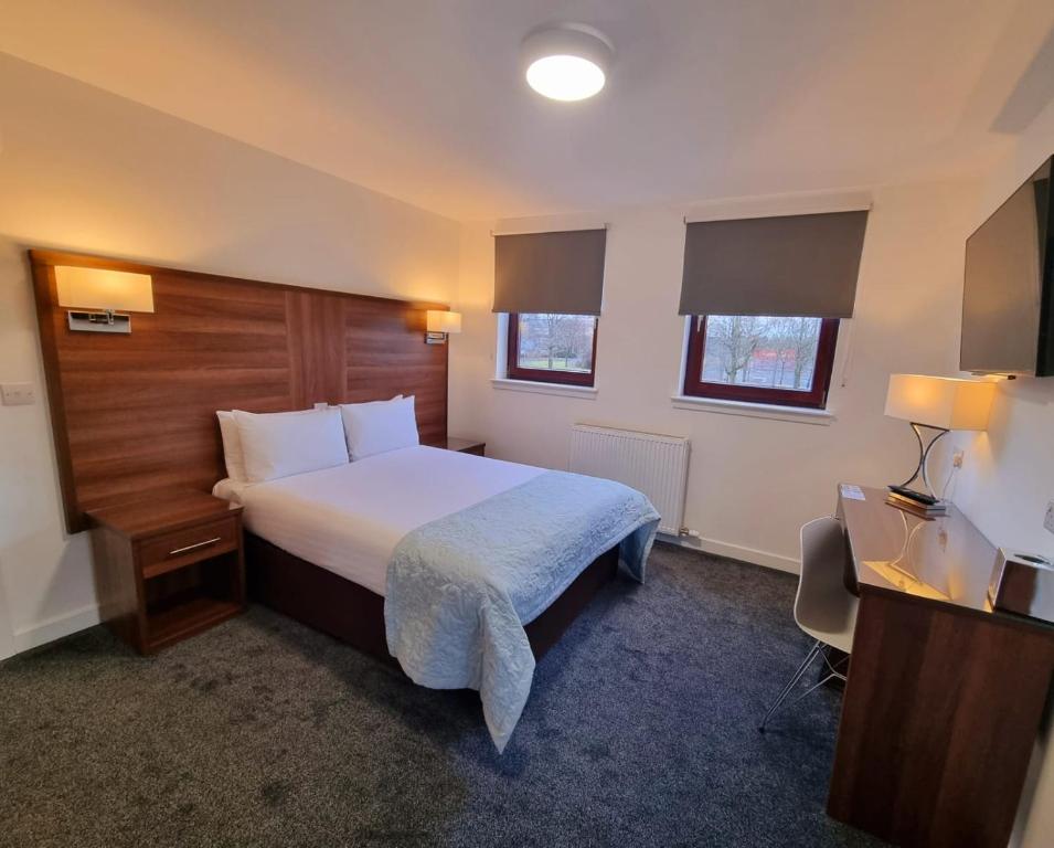 Postel nebo postele na pokoji v ubytování Premier Lodge