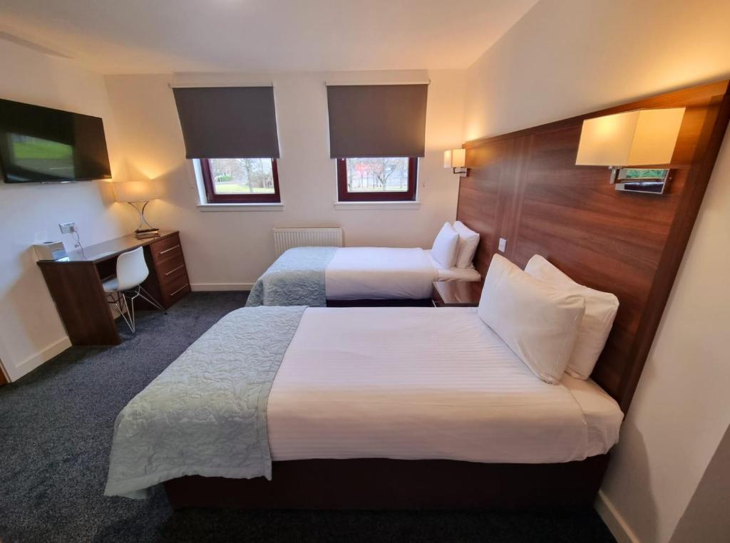 Postel nebo postele na pokoji v ubytování Premier Lodge