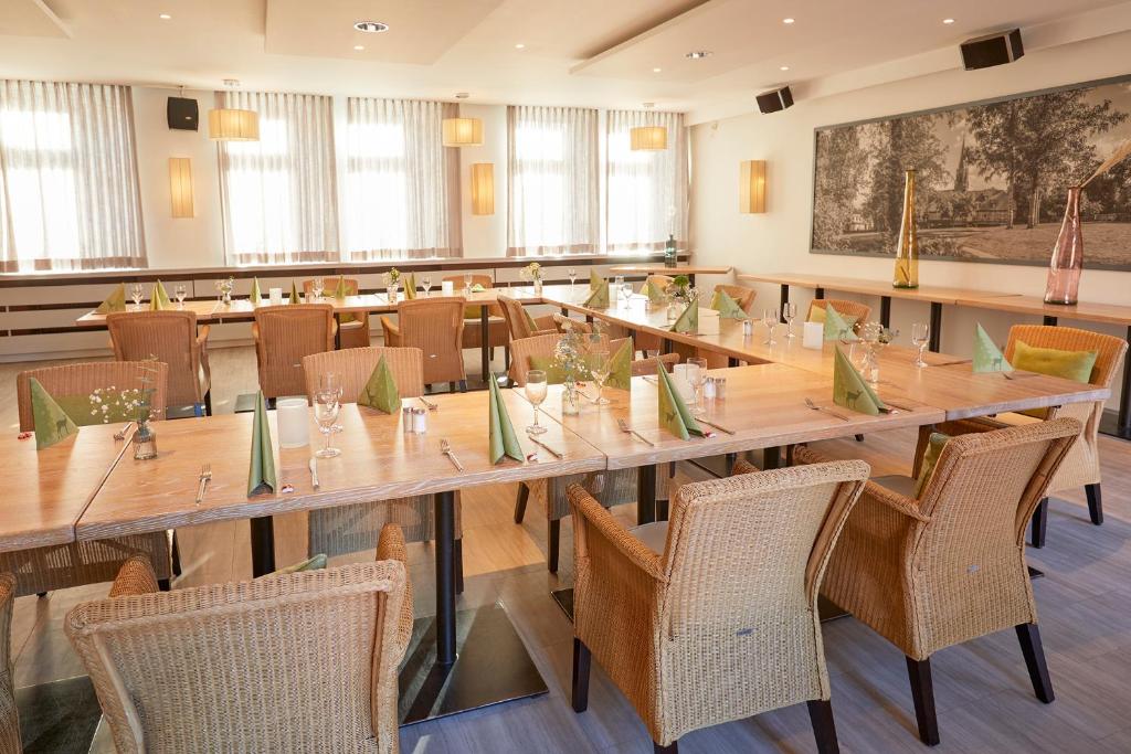 a large conference room with a long table and chairs at Kino-Hotel Meyer in Harsefeld
