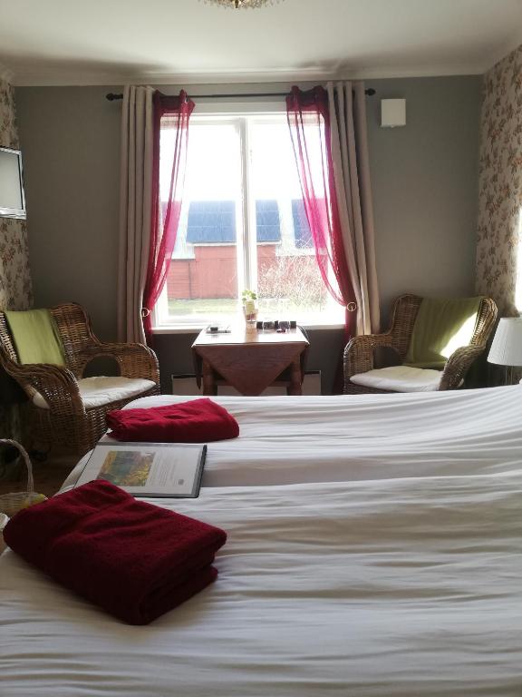 Postel nebo postele na pokoji v ubytování Karlsberg Gård B&B