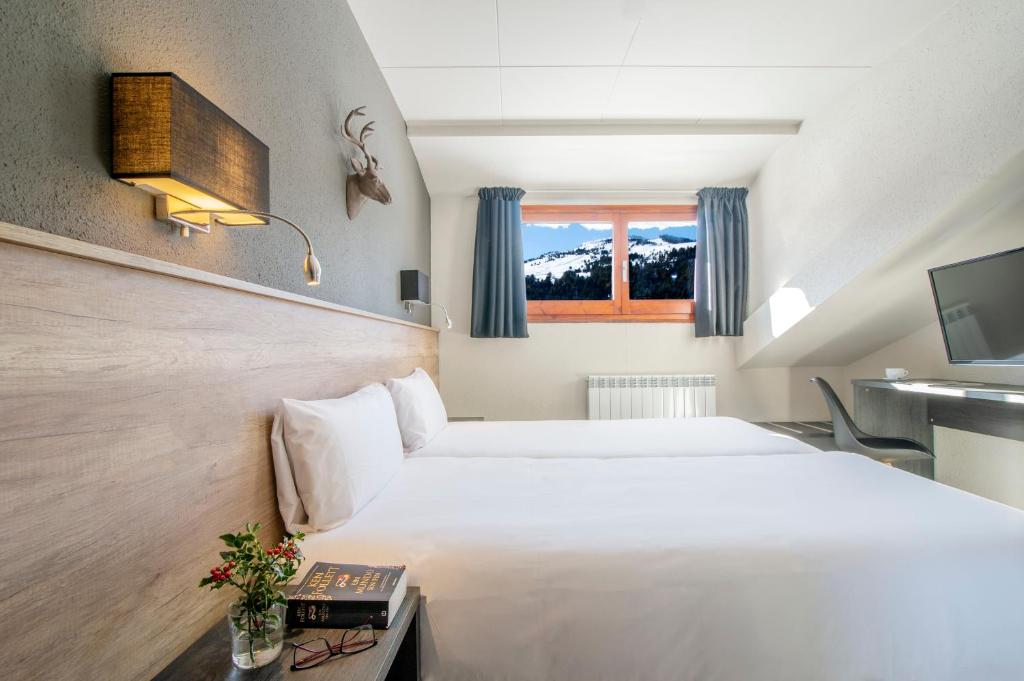Säng eller sängar i ett rum på Hotel Austria by Pierre & Vacances