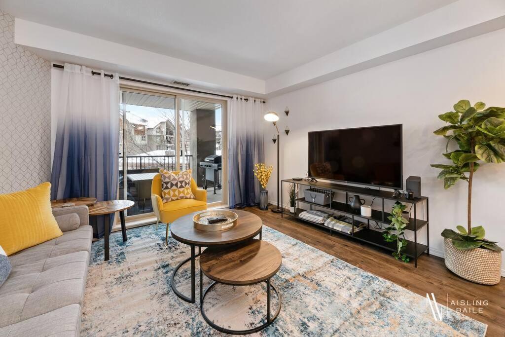 a living room with a couch and a tv at Chic Retreat, Modern, Pool, Hot Tub, Gym in Invermere