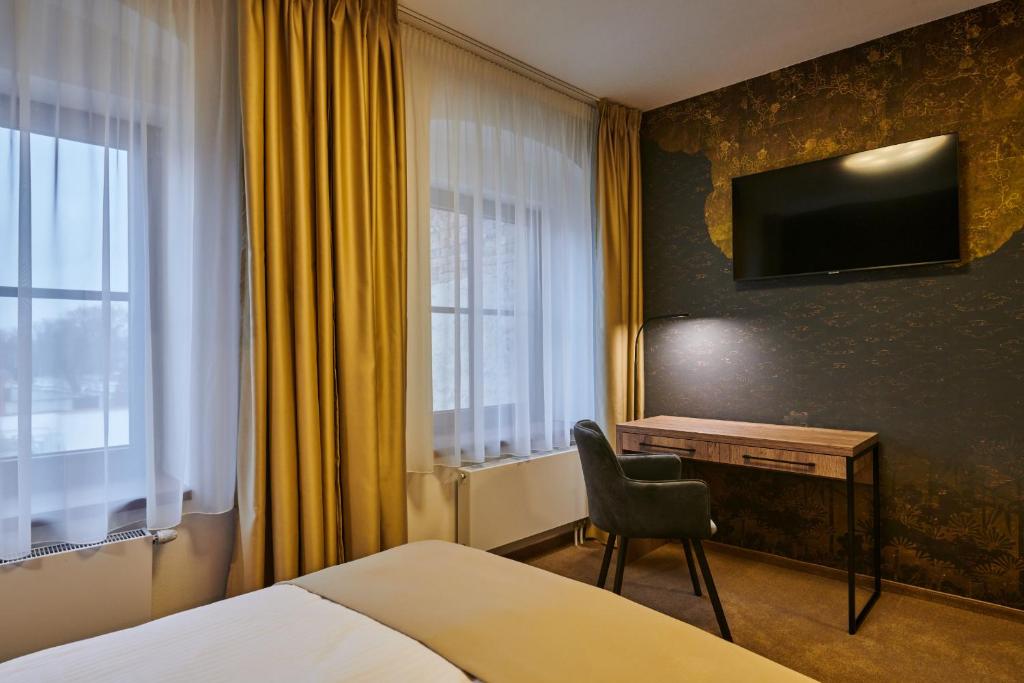 Postel nebo postele na pokoji v ubytování Hotel Alfréd a Hermína