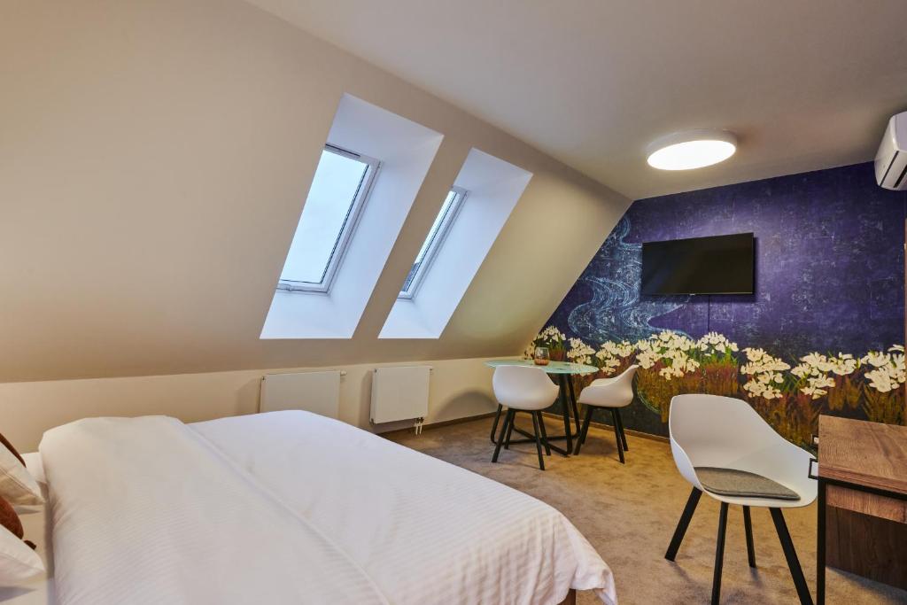Postel nebo postele na pokoji v ubytování Hotel Alfréd a Hermína