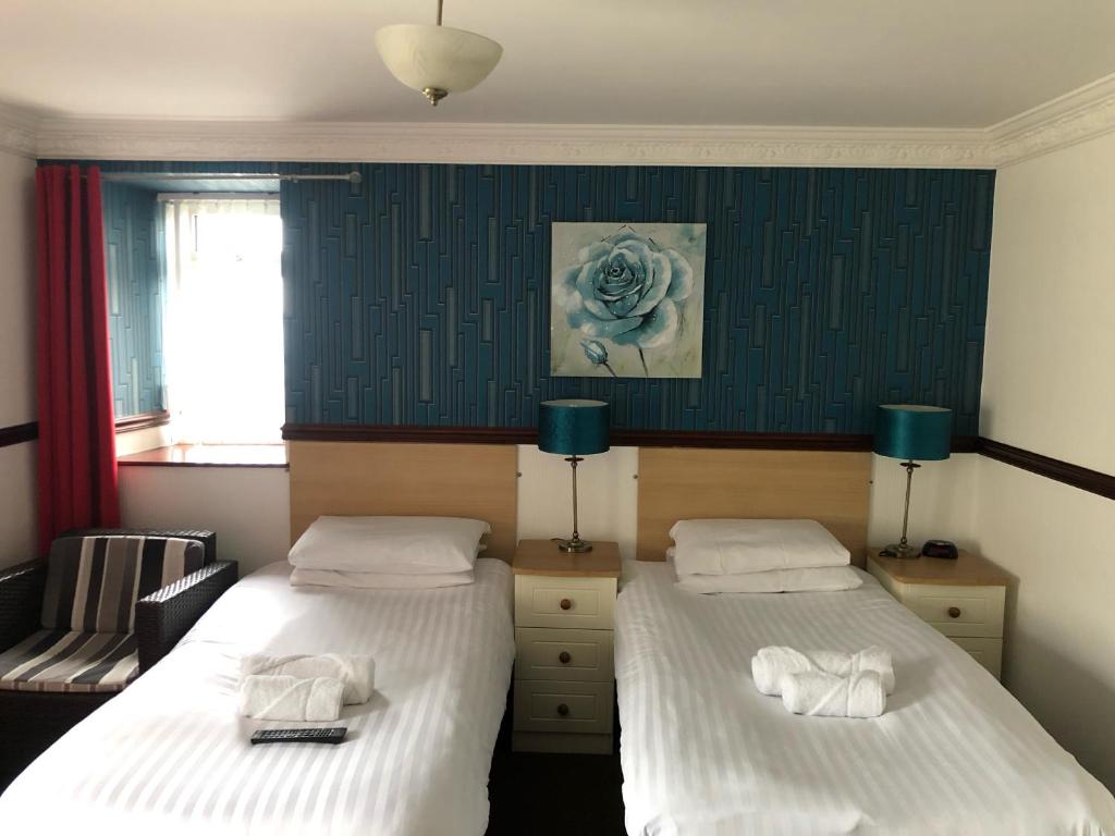 Postel nebo postele na pokoji v ubytování Boathouse Hotel
