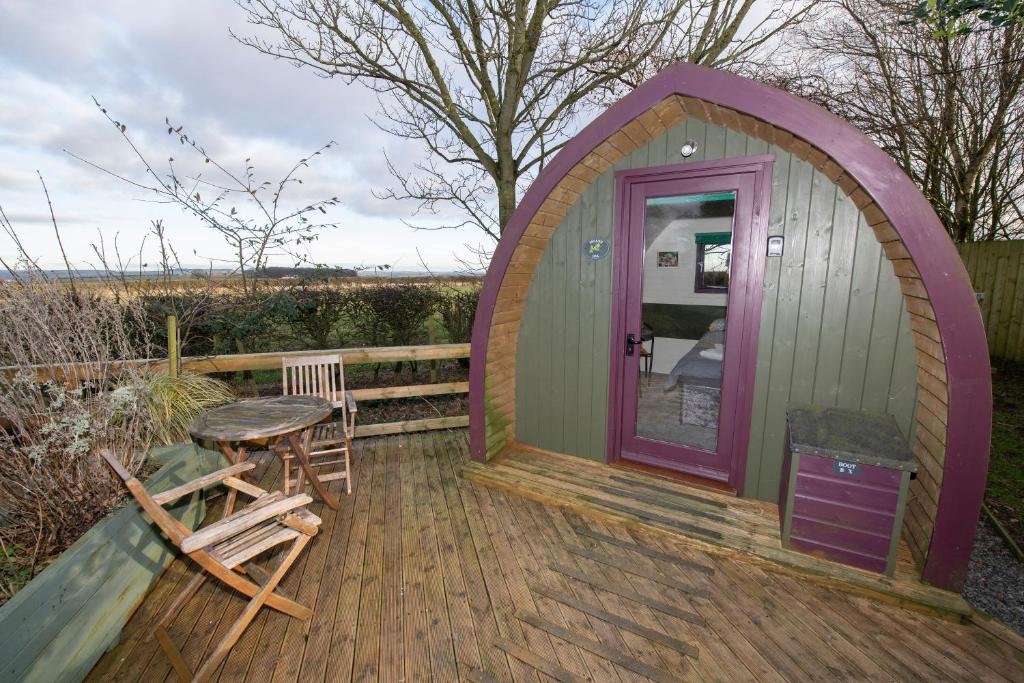 a gazebo with a table and chairs on a deck at Seaways glamping, English Oak in Great Driffield