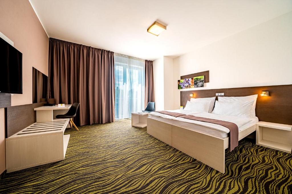 Postel nebo postele na pokoji v ubytování Maximus Resort