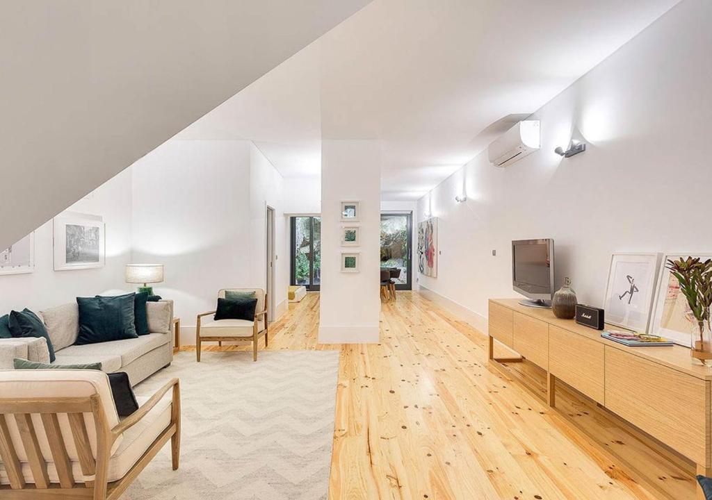 a living room with a couch and a tv at Own Places Casa do Bonas in Porto