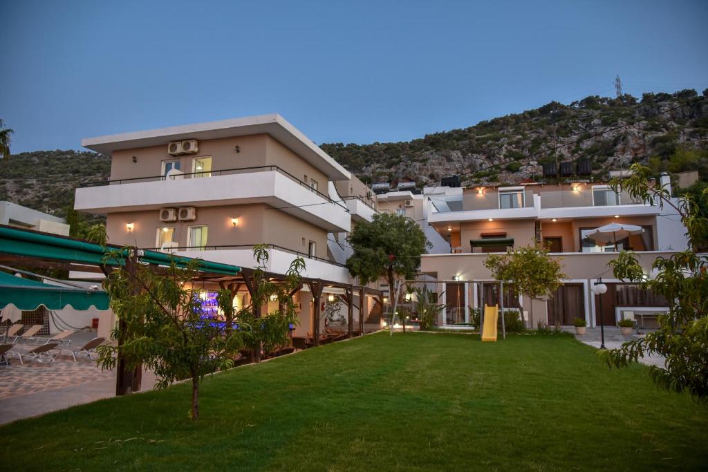 a large building with a lawn in front of it at Iraklis Apartments in Stalís