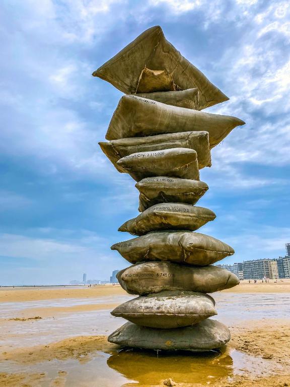 a pile of rocks stacked on top of a beach at CASA MARE hartje Oostende met gratis parking in Ostend