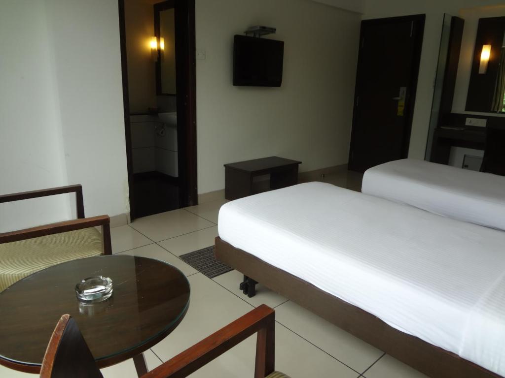 Postel nebo postele na pokoji v ubytování Shantai Hotel