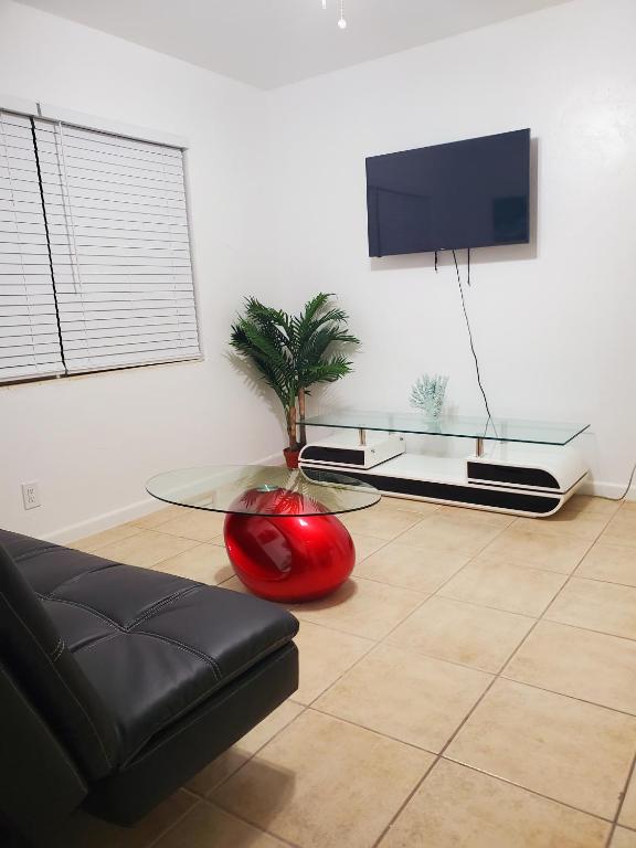 a living room with a couch and a glass table at Singer Island Inn in West Palm Beach