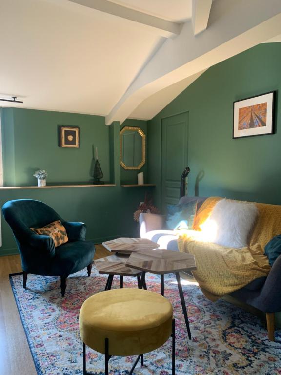 a living room with green walls and a couch and chairs at Bel Appartement Vieux Rouen in Rouen