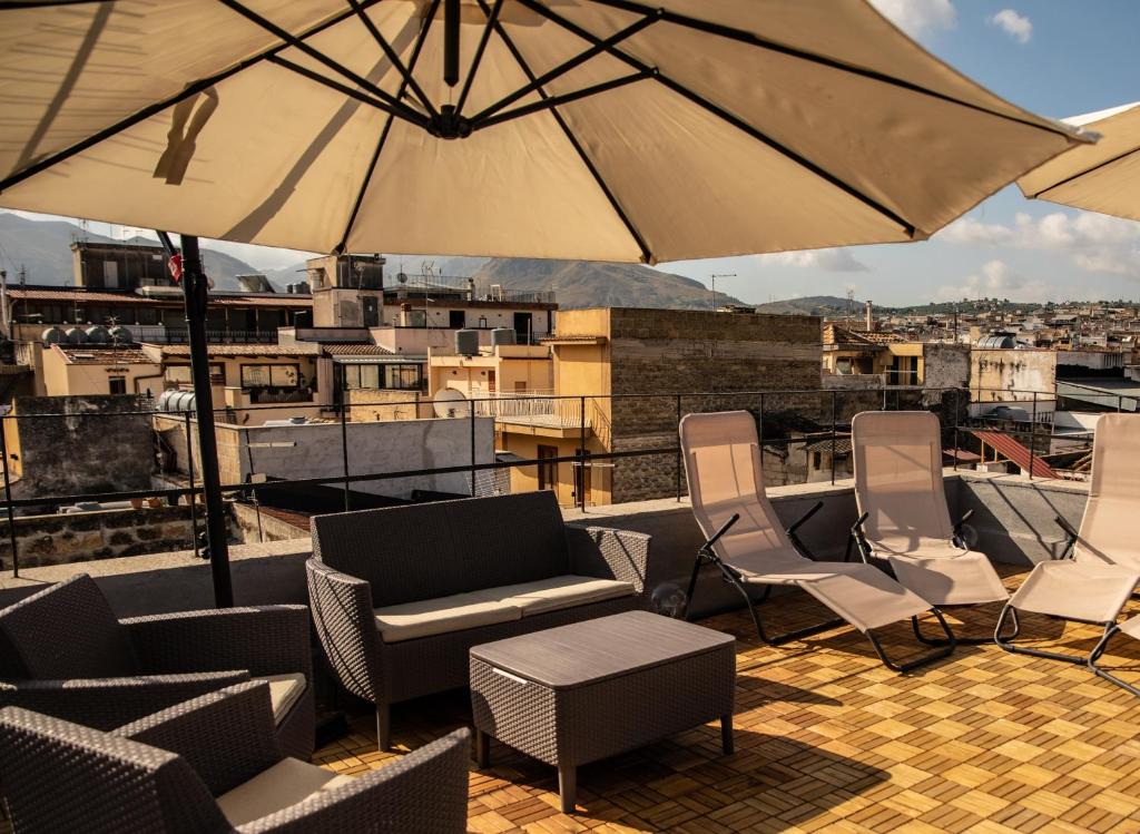 patio con sedie e ombrelloni sul tetto di alfaapartment & beautiful 20-metre terrace a Casteldaccia